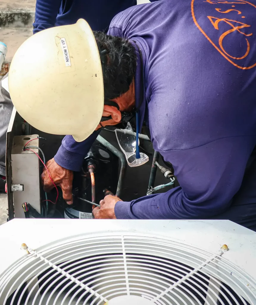 Maintenance man repair air conditional and air compressor